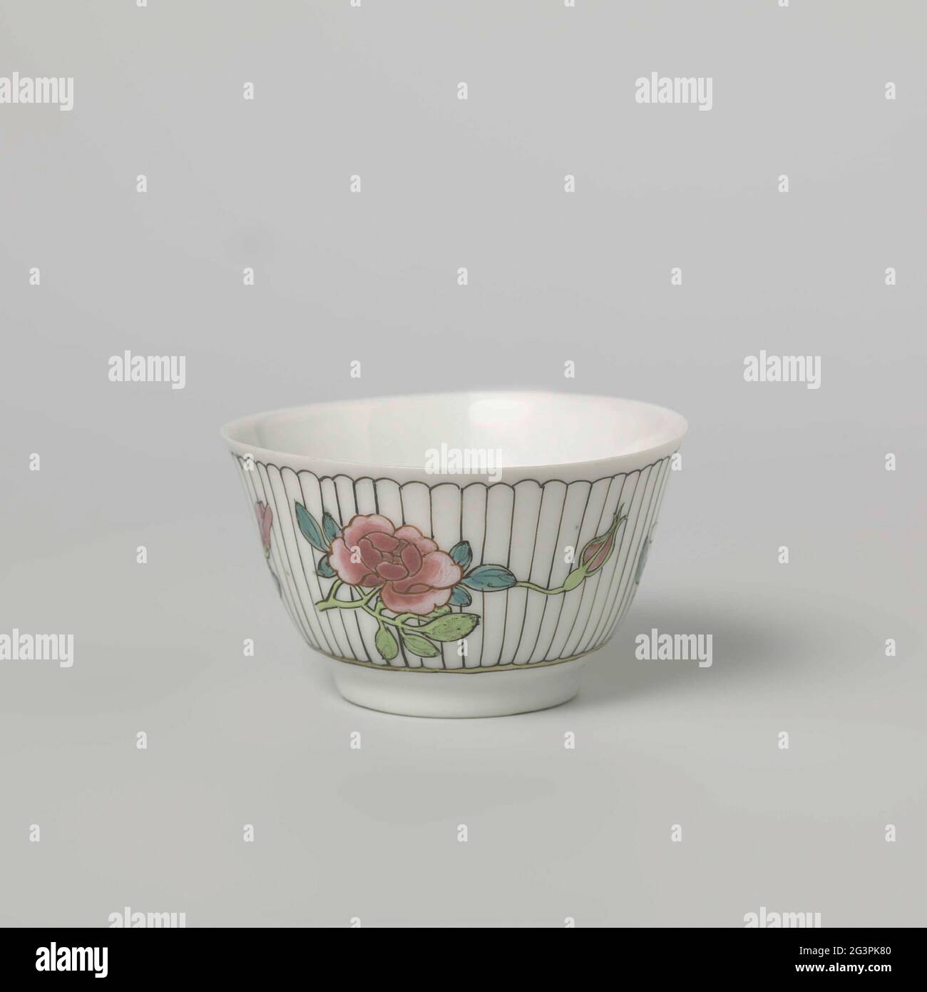 Bell-Shaped Cup with Three Flower Sprays on a Verticly Striped Ground. Bell-shaped head of porcelain, painted on the glaze in blue, red, pink, green, yellow, black and gold. Three flour branches (peony, magnolia, iris) on a vertical striped soil on the outside. A stylized flower on the bottom. Family Rose. Stock Photo