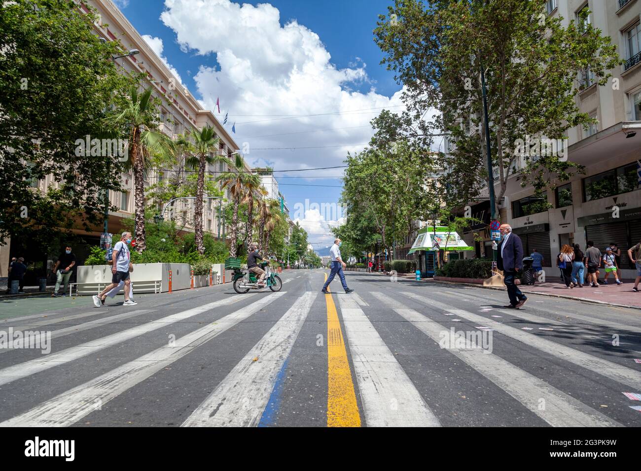 Athenians walking on crosswalk on Panepistimiou avenue, one of the busiest (usually) main streets in Athens, Greece, Europe. Stock Photo