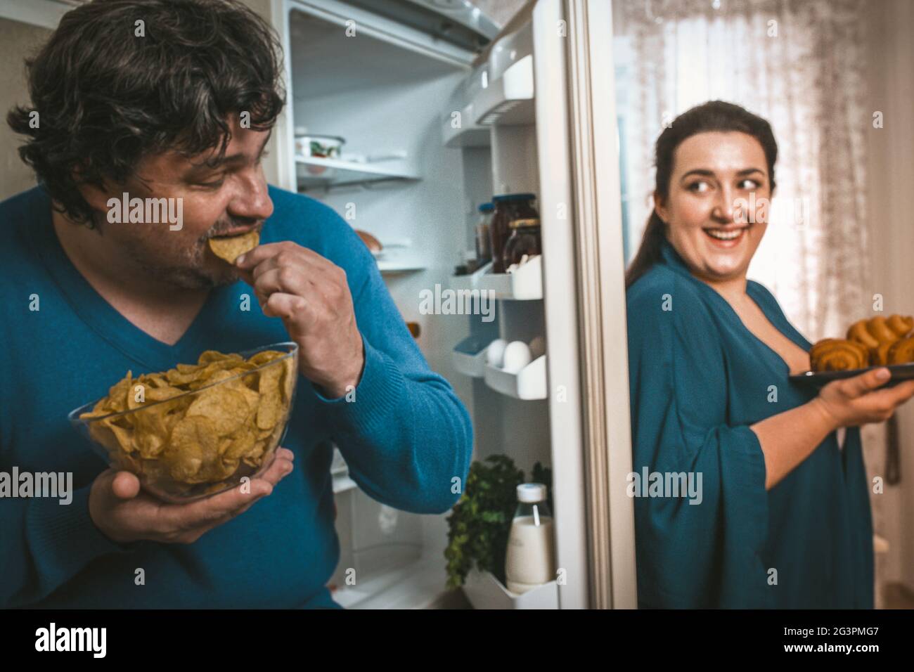 Hungry Body Positive Couple Eating Of Unhealthy Food Stock Photo