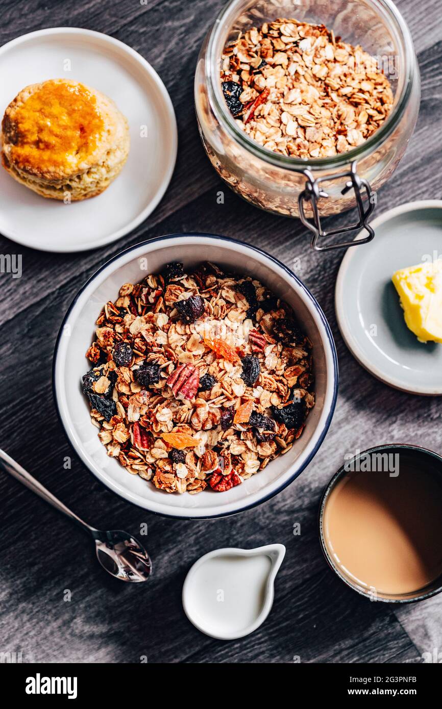 Fruit Granola Cereal Breakfast Bowl with Milk on Wooden Background