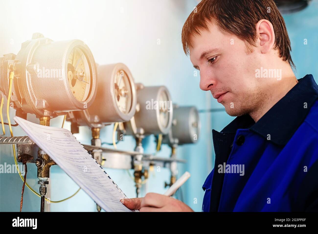 Engineer, worker registers readings of sensors and pressure gauges. Control of water supply and heat Stock Photo