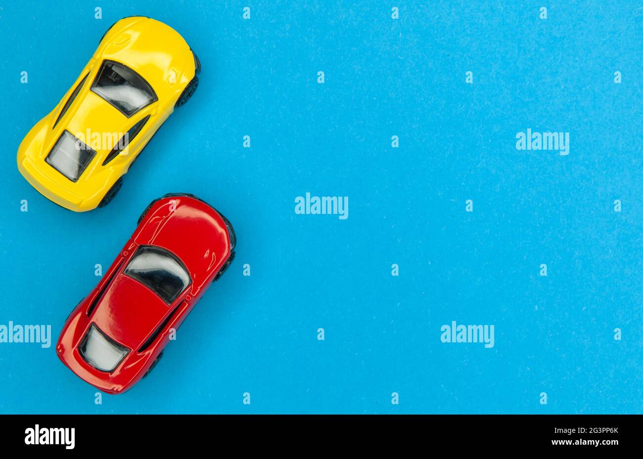 Yellow and red toy cars on a blue background, top view. Stock Photo