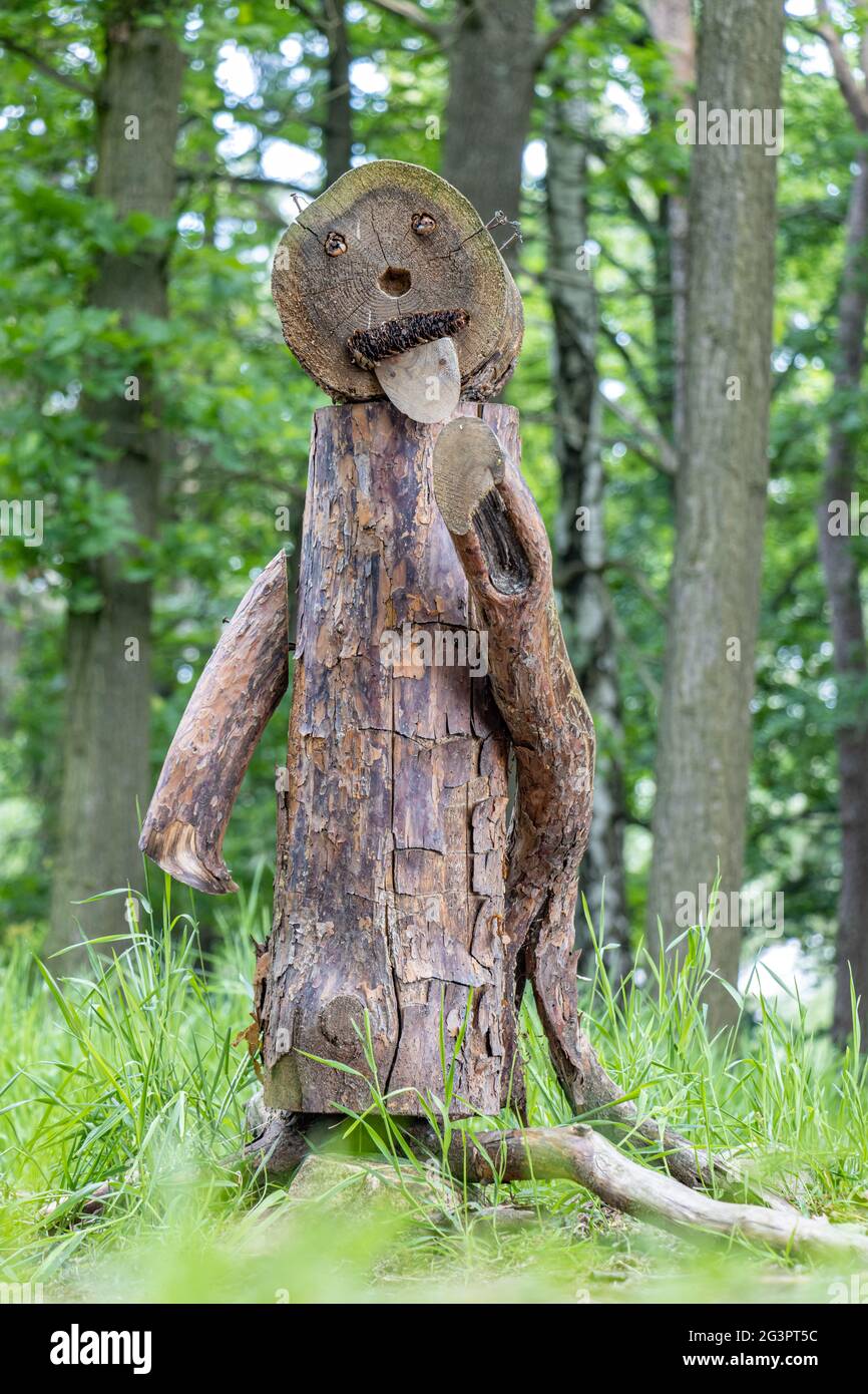 Funny figure made of wood stands in the woods Stock Photo - Alamy