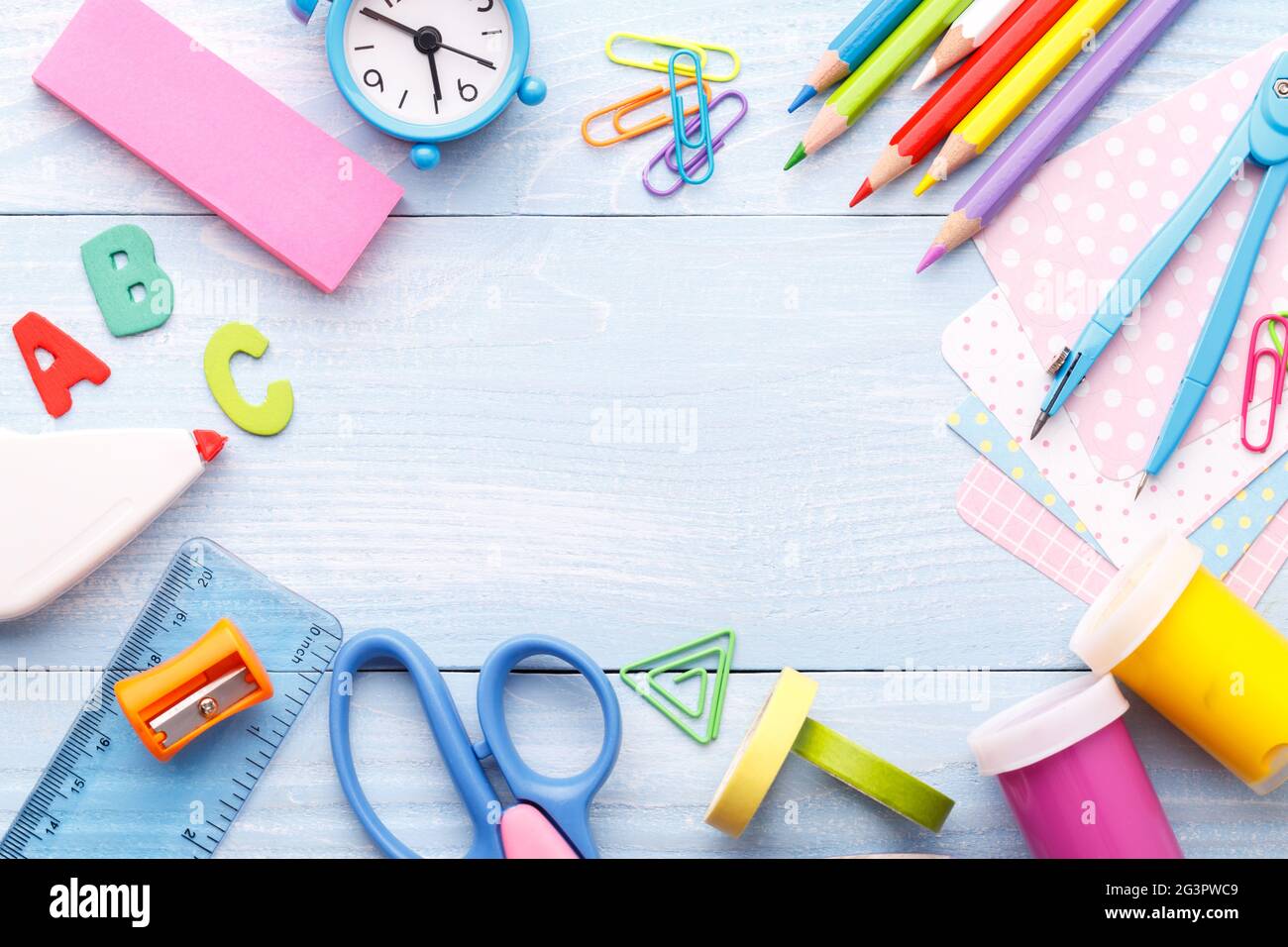 Colorful stationery on blue desk Stock Photo - Alamy