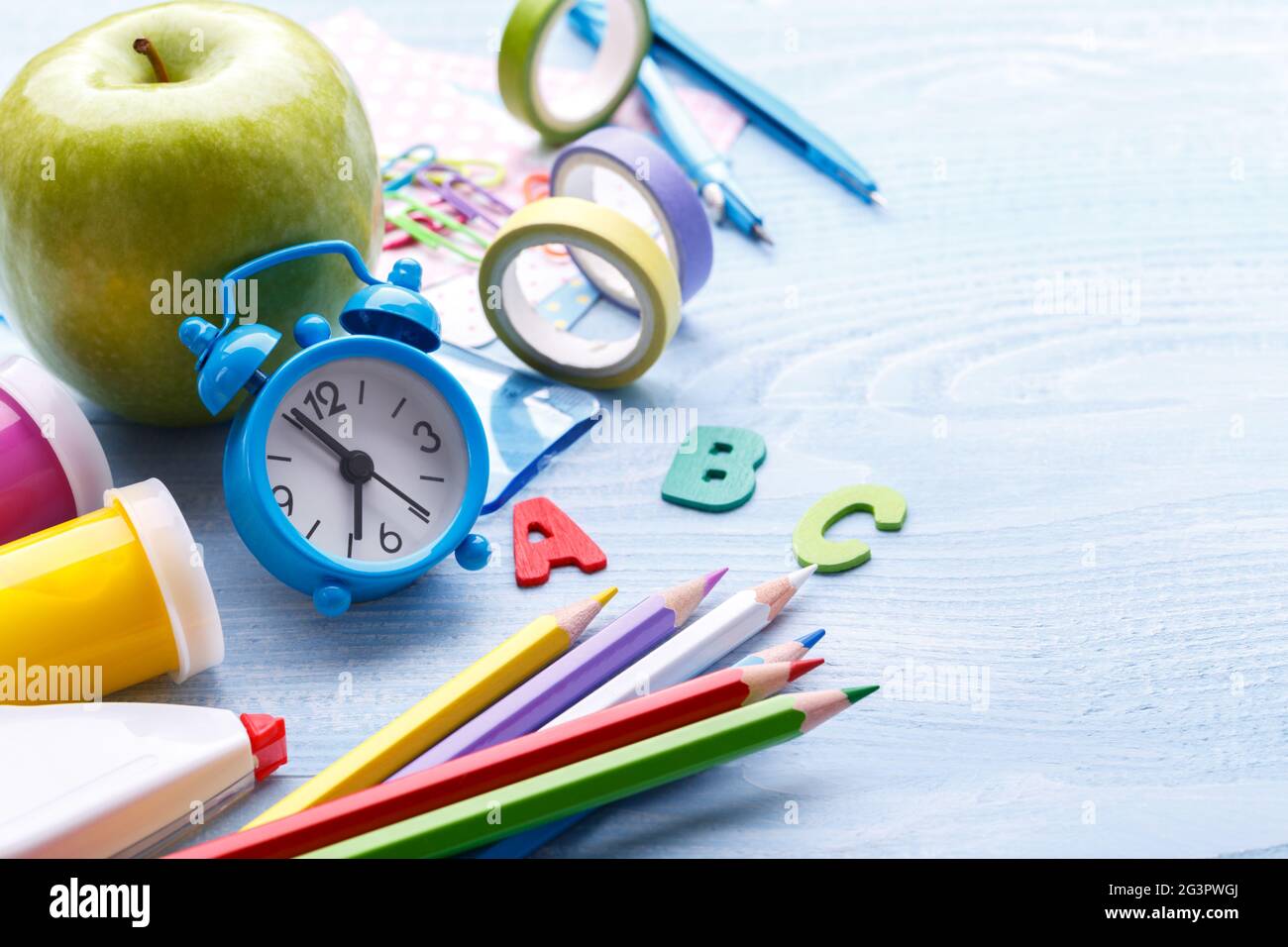 Colorful stationery on blue desk Stock Photo - Alamy