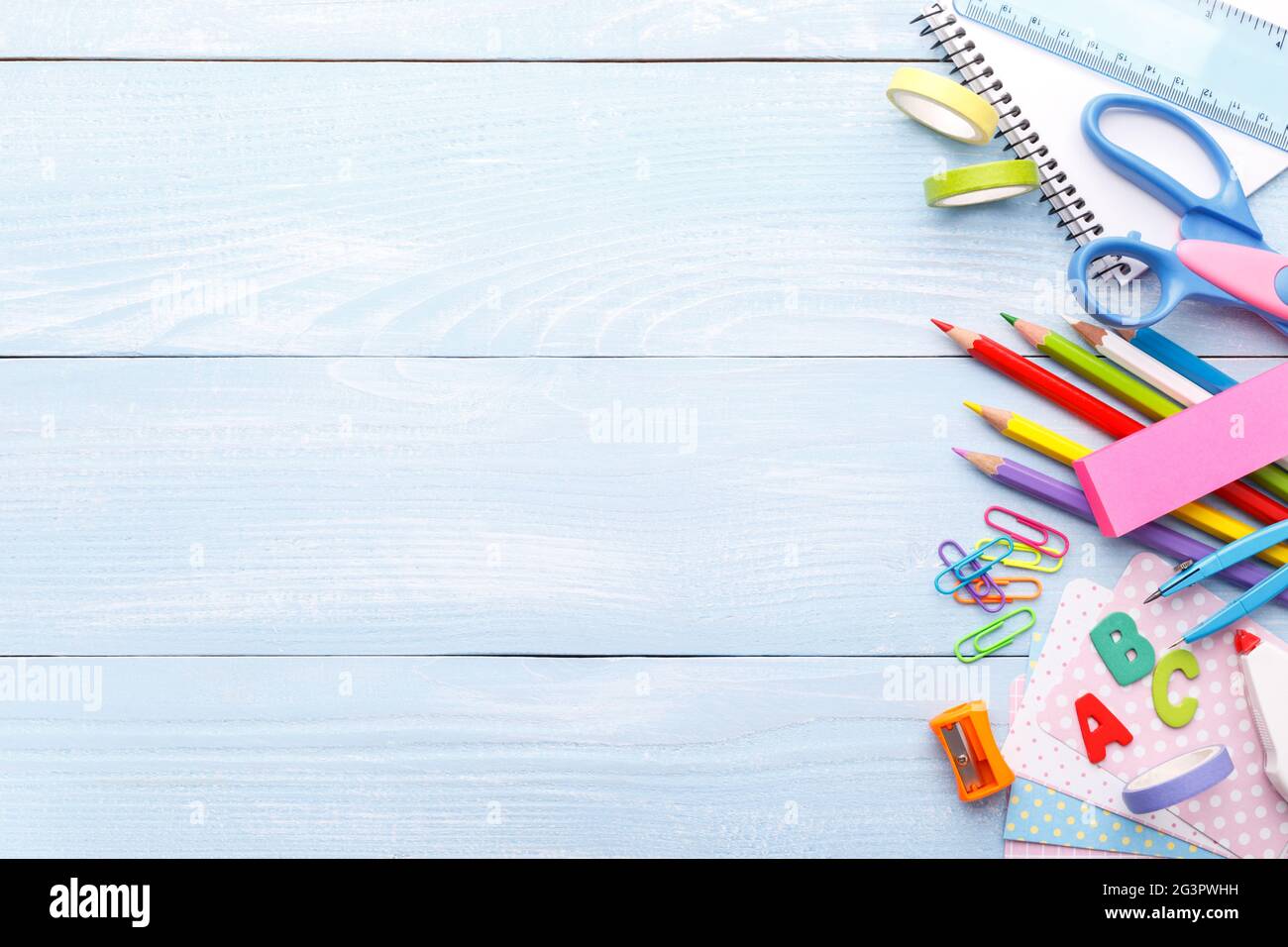 Colorful stationery on blue desk Stock Photo - Alamy