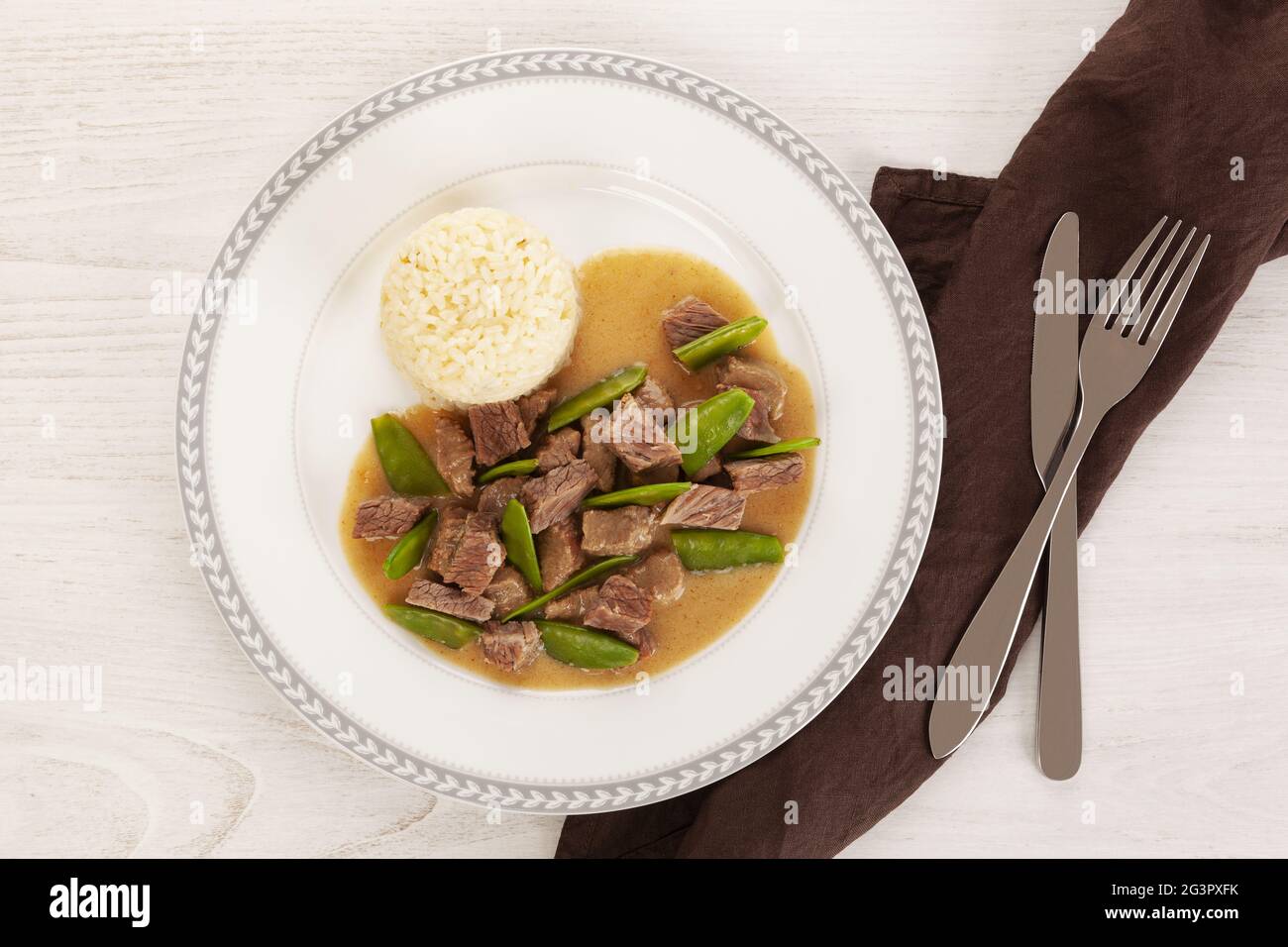 Beef meat stewed with baby peas. Stock Photo