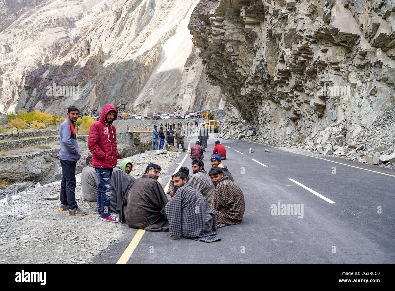 The group of truck drivers waiting when the road will be clear because of landslide Stock Photo