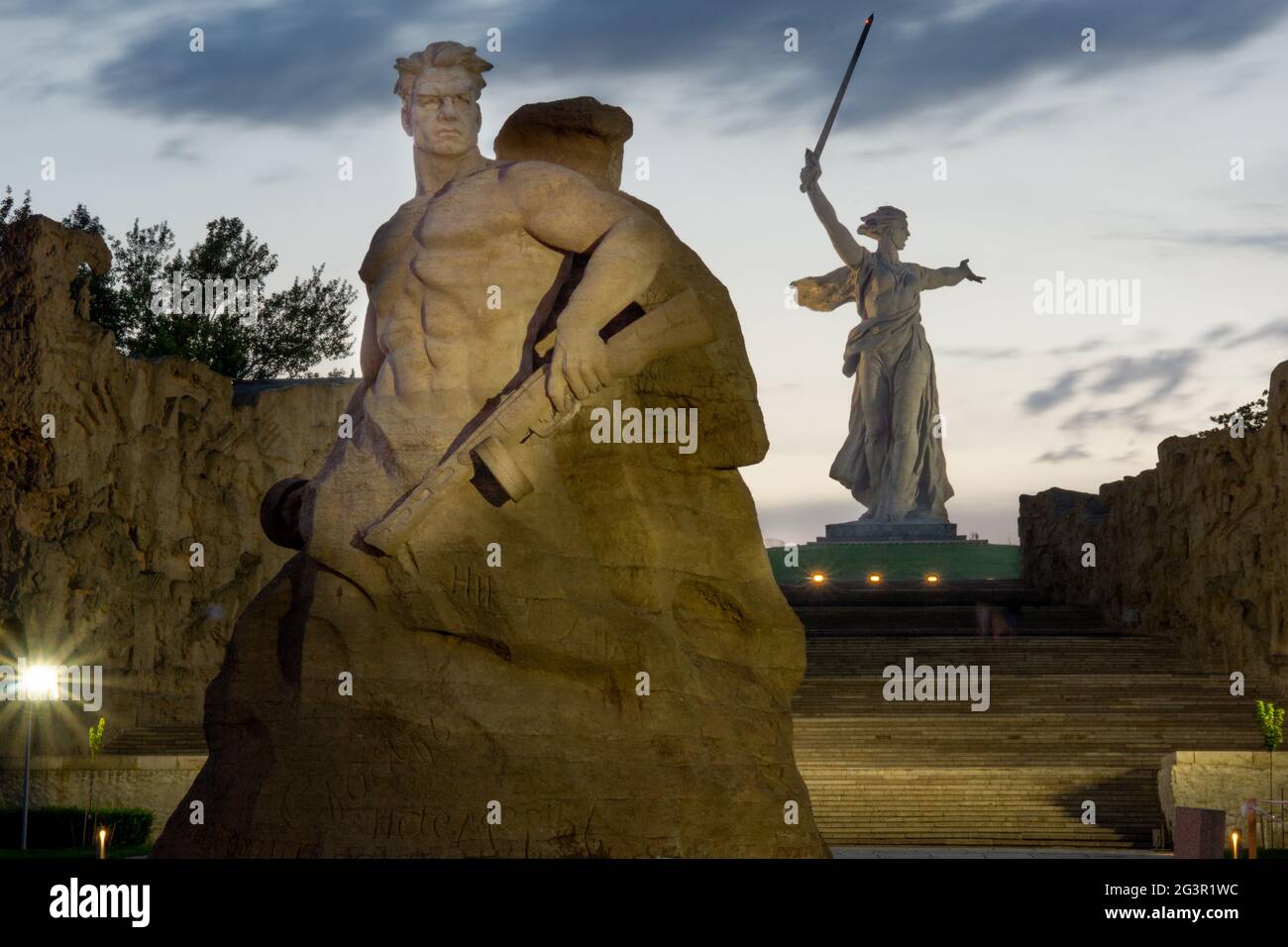 Volgograd/Russia-18.06.2016:The statue of The Motherland Calls on Mamayev Kurgan and soldier statue with gun Stock Photo