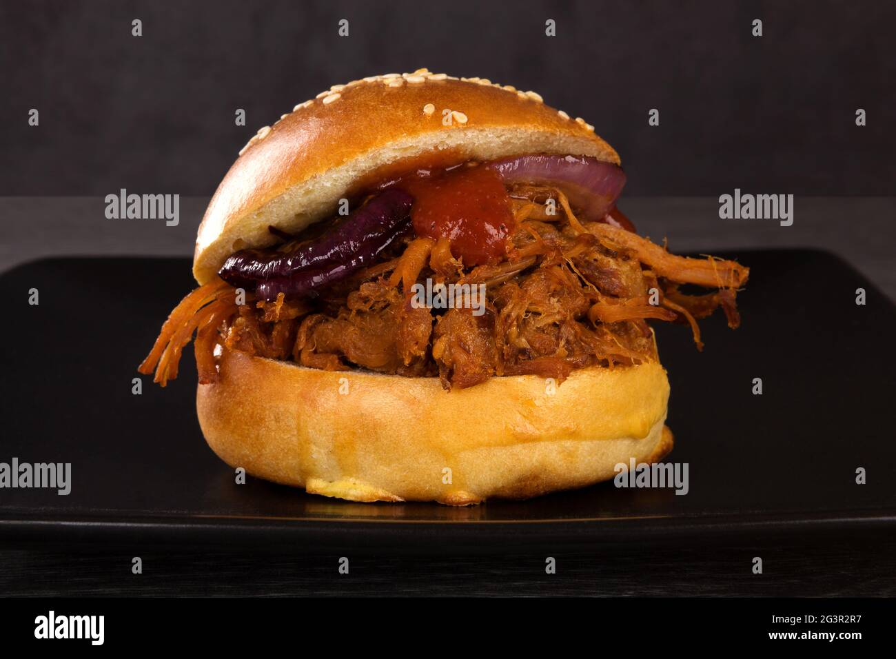 Bbq pulled pork burger on black. Stock Photo