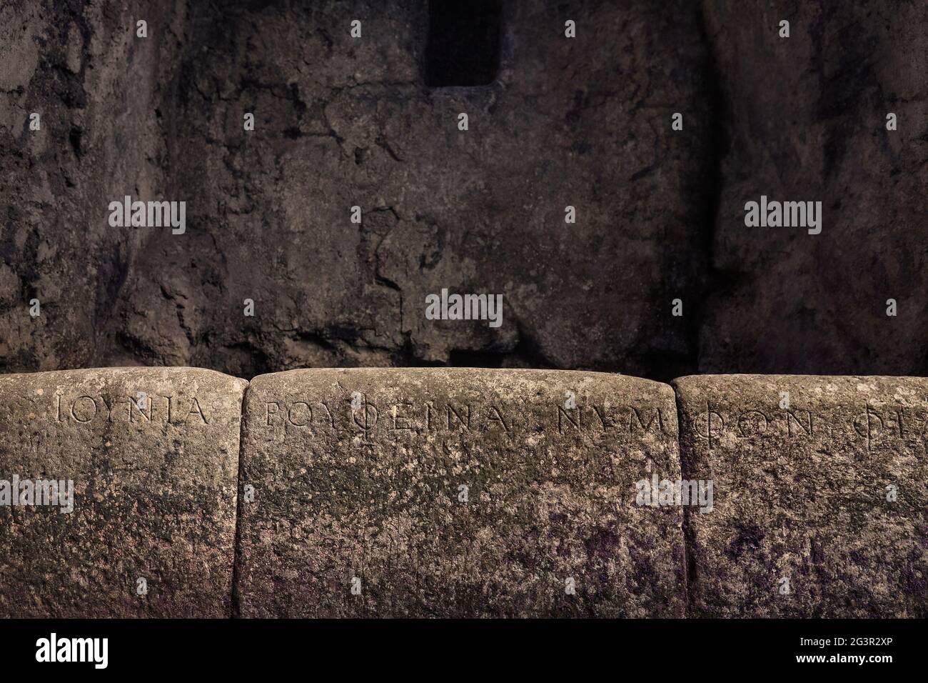 Ancient script engraved on the walls of the Butrint temple in Albania. Stock Photo