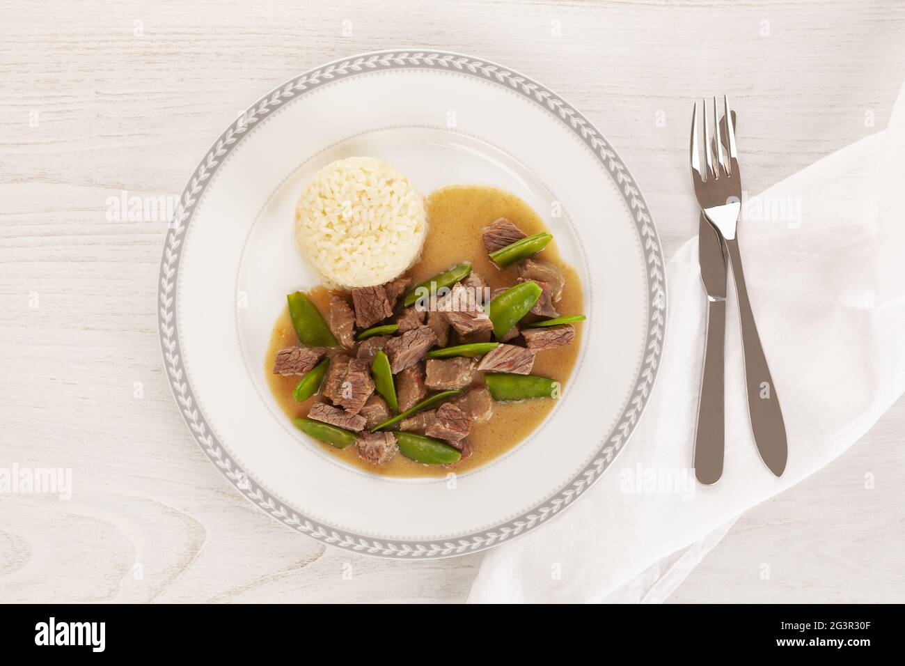 Beef meat stewed with baby peas. Stock Photo
