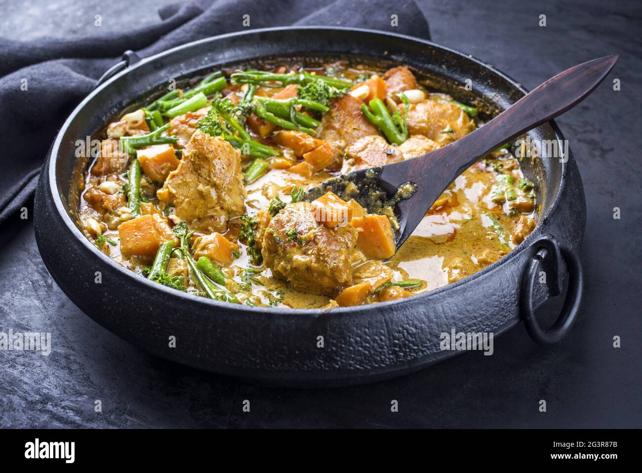 Modern style African crocodile cheeks curry with sweet potato Stock