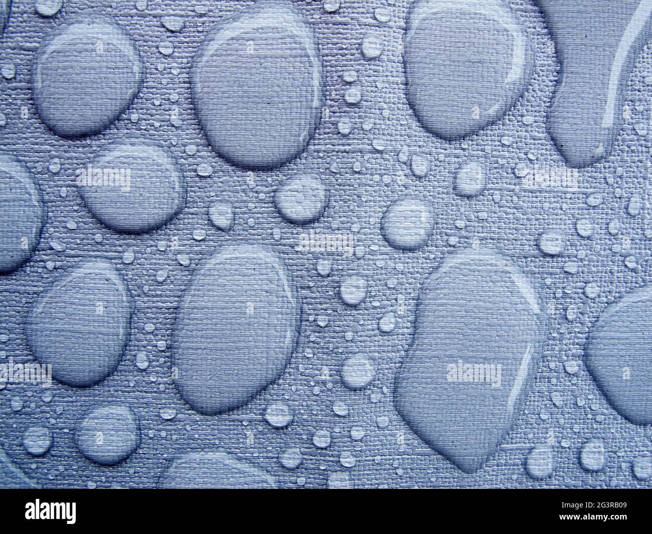 Raindrops on a blue tablecloth kinked Stock Photo