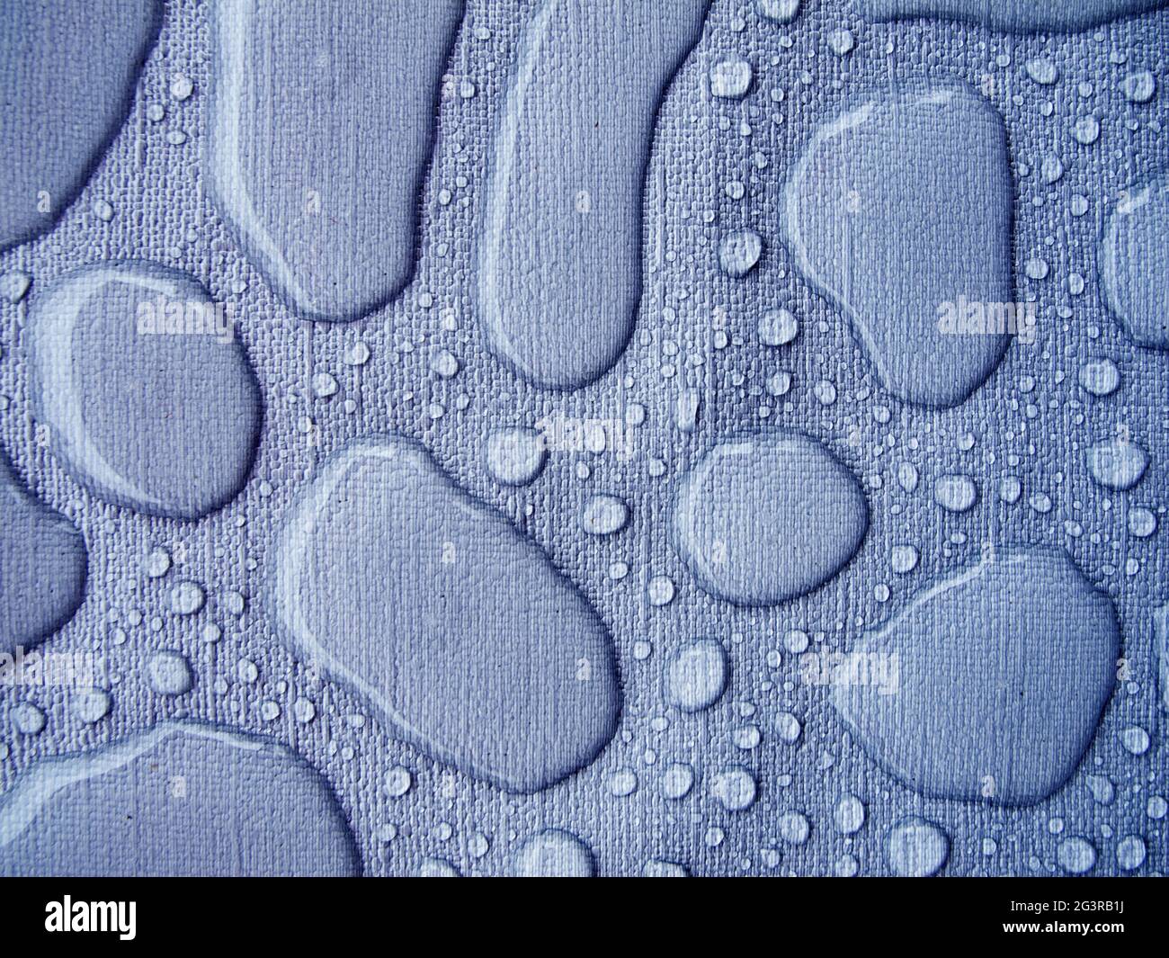 Raindrops on a blue tablecloth horizontal Stock Photo