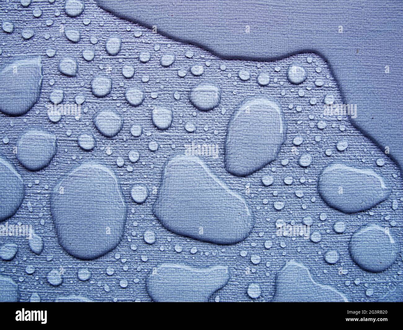 Raindrops on a blue tablecloth near Stock Photo