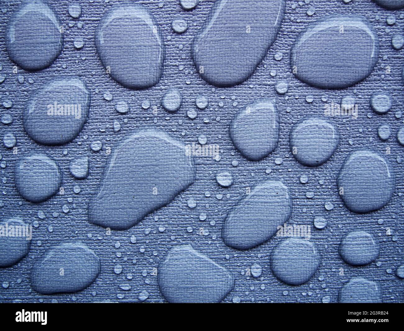Raindrops on a blue tablecloth Stock Photo