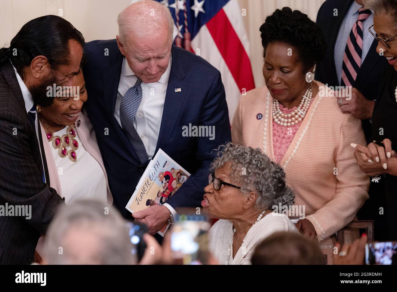 . President Joe Biden speaks with . Rep. Barbara Lee (D-CA) as Opal  Lee, a 94-year-old activist and retired educator in Fort Worth, Texas,  speaks with . Rep. Al Green (D-TX) during