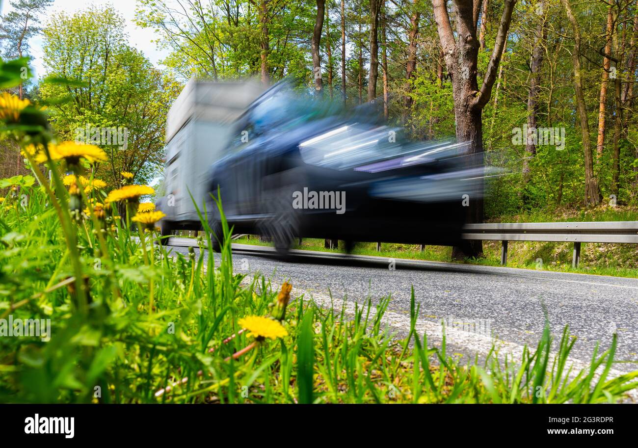 Fast car in green nature in spring Stock Photo