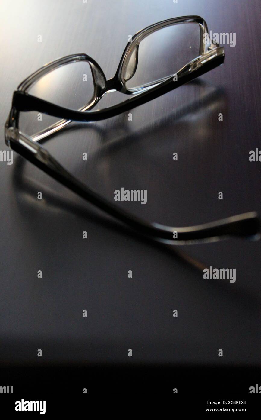 Stylish glasses lie on a gray laptop. Close-up Stock Photo