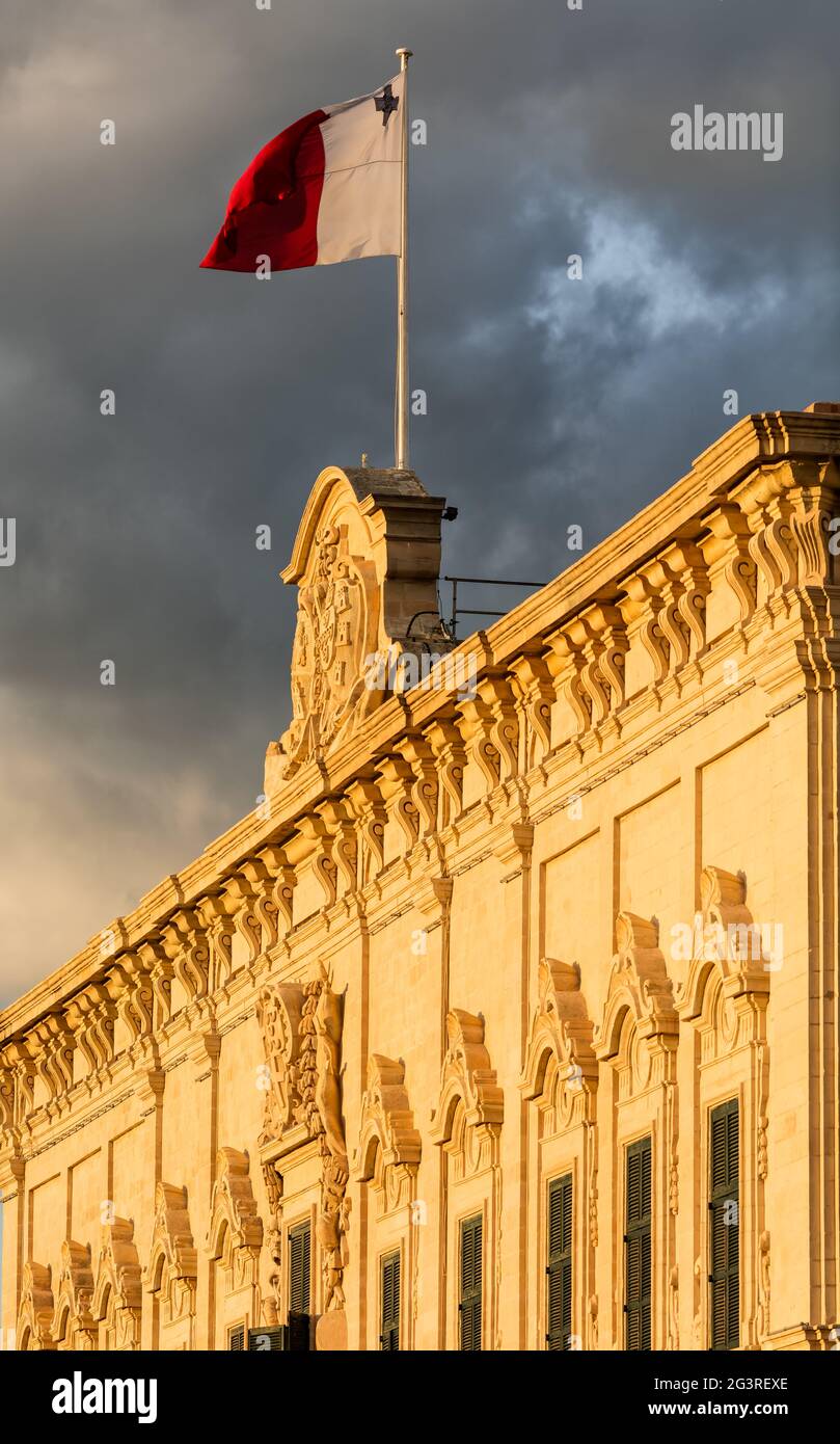 Malta Valletta Goverment Building / Auberge de Castille - Malta Flag, dramatic clouds, politics Stock Photo