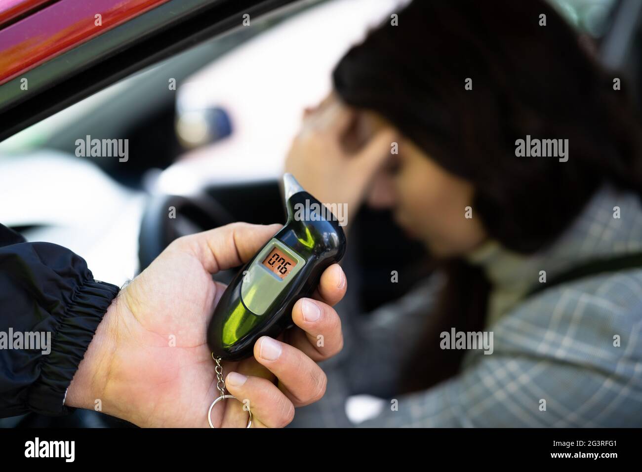 Sad Woman With Alcohol Intoxication Stopped By Policeman Stock Photo