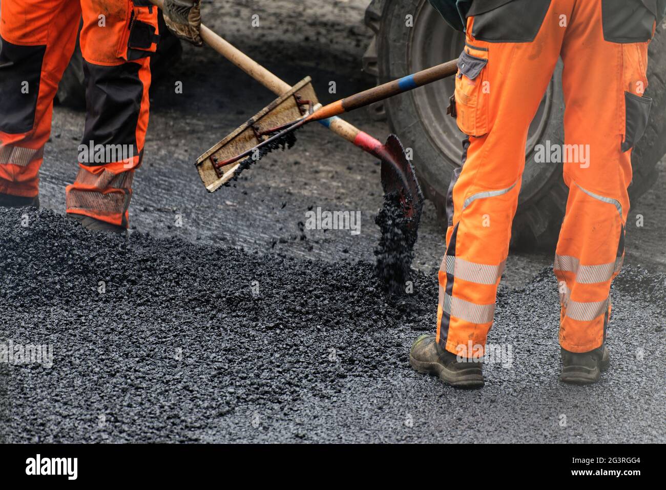 Asphalt builders spread and compact Stock Photo