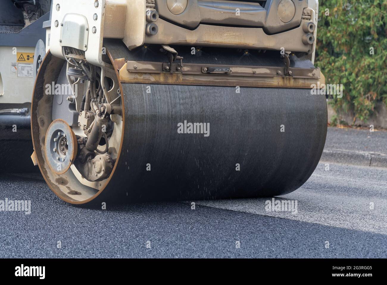 Tandem roller compacts new road surface Stock Photo