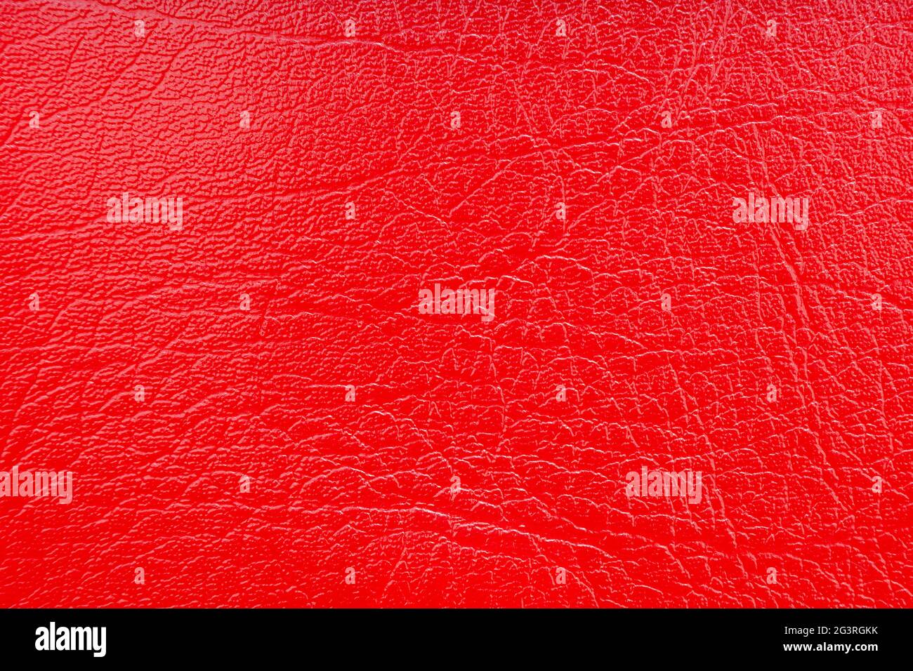 Background image - red leather with an abstract texture. Stock Photo