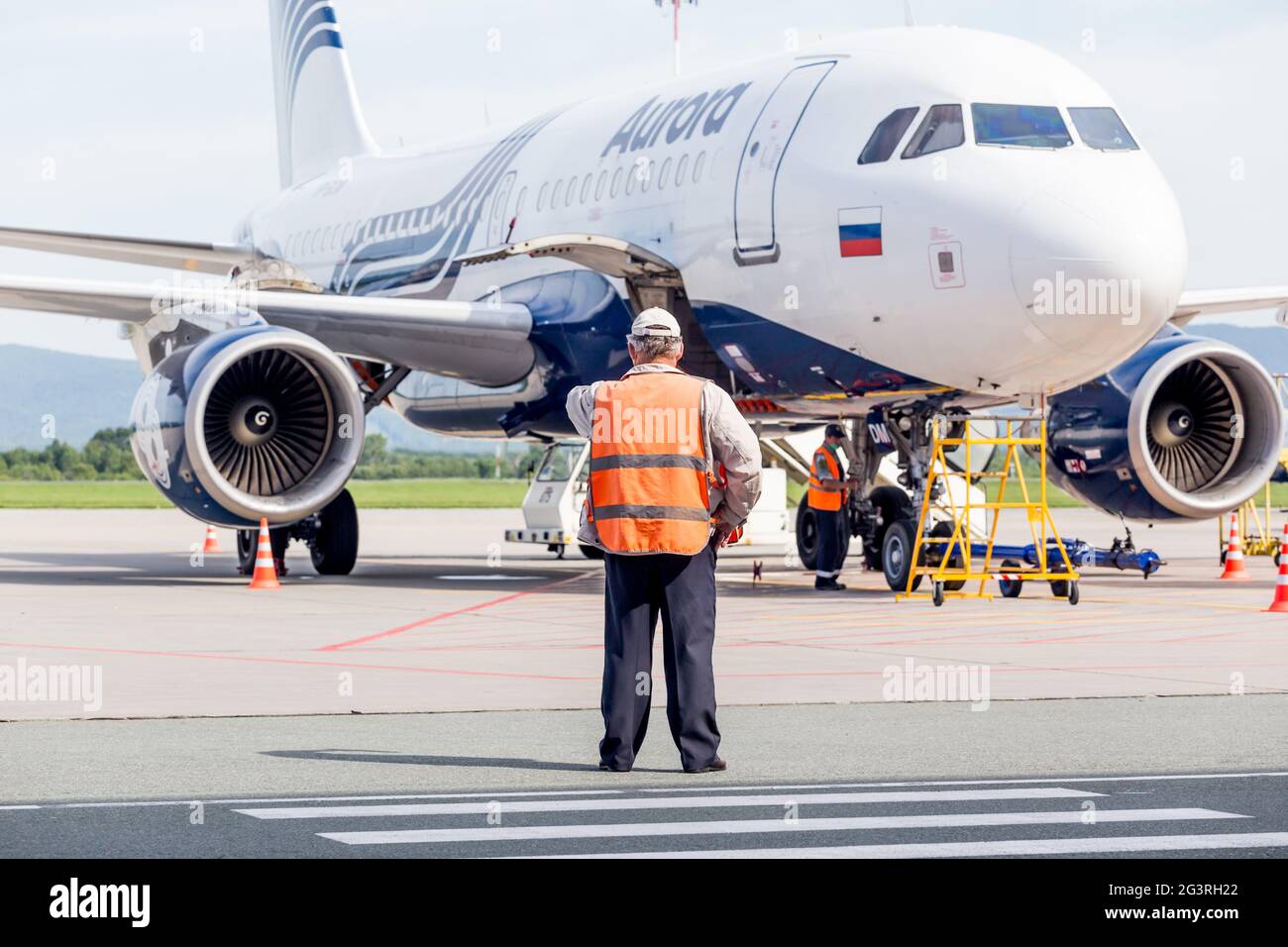 Russia, Vladivostok, 08/17/2020. Passenger jet Airbus A319 of Aurora Airlines check before taking off. Plane maintenance and ser Stock Photo