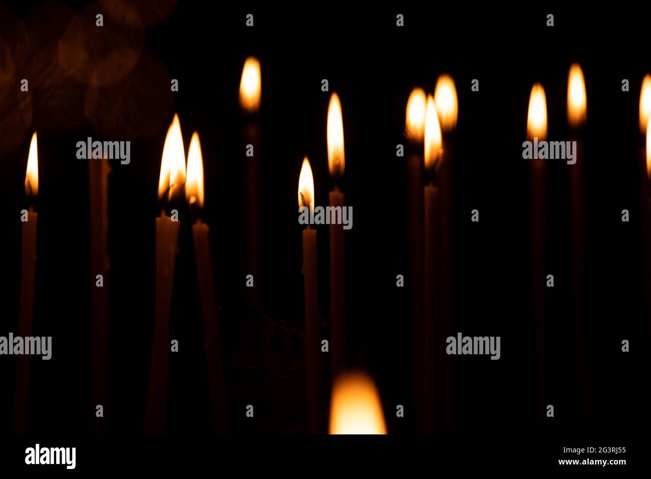 close up a lot of burning candles isolated on black background Stock ...