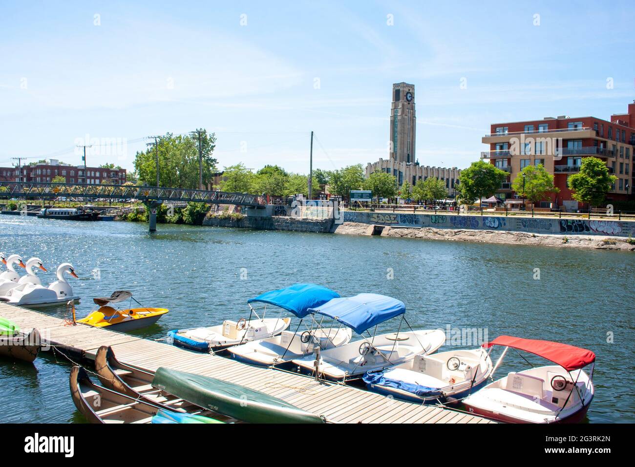 Montreal's Atwater Market seen across a boat rental dock and the Lachine Canal Stock Photo