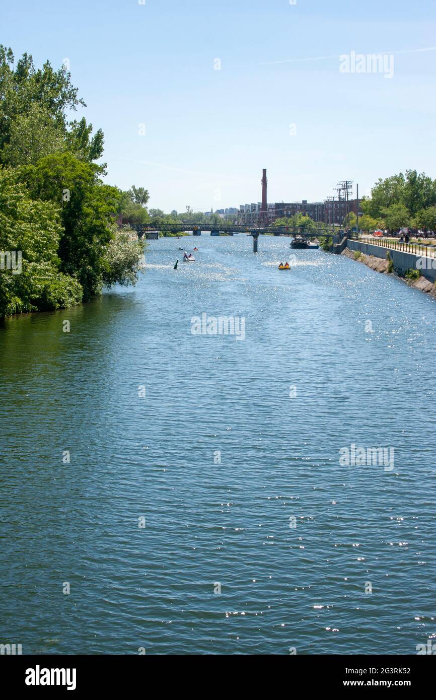 Boats float along the Lachine Canal near Montrael's Atwater Market on a sunny day Stock Photo