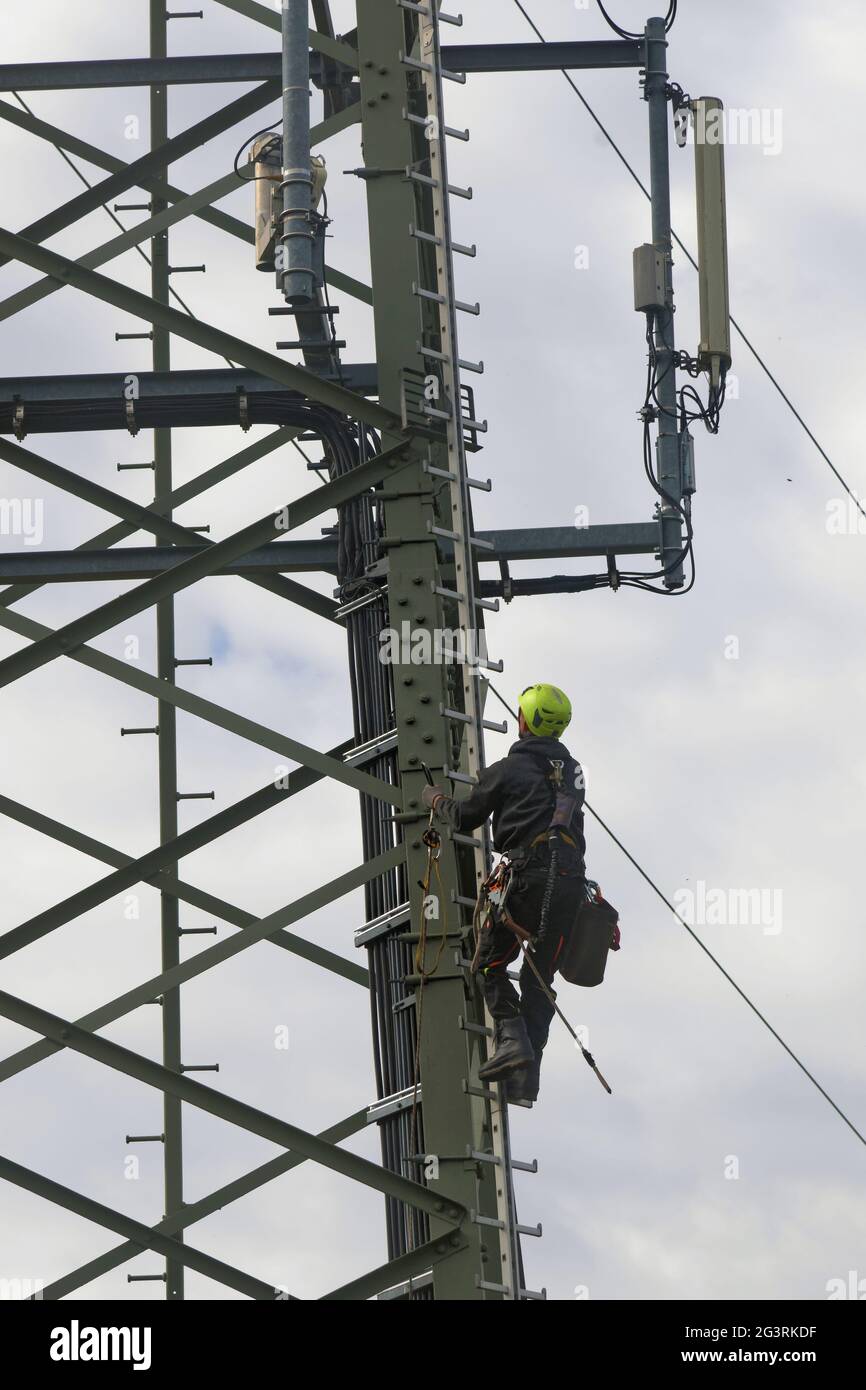 Mobile phone mast with installer Stock Photo