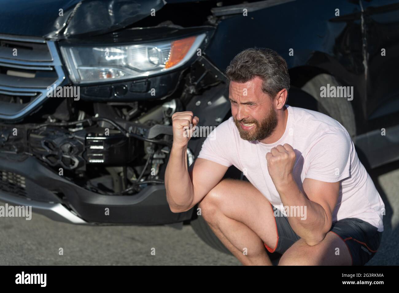 frustrated man driver at broken car after automobile collision car accident, car insurance Stock Photo