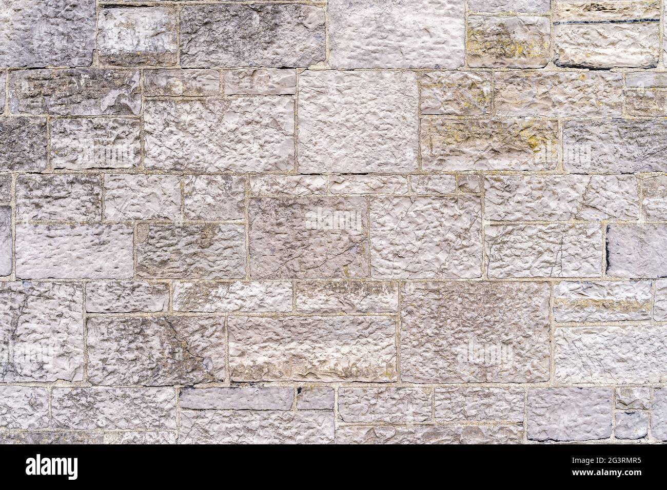 Old, rustic white or beige brick or stone wall. Stock Photo
