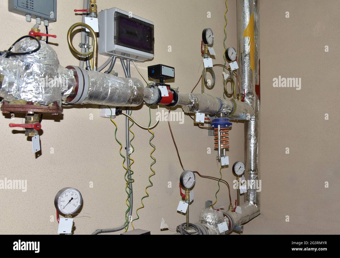 Heating system in boiler room at home. Round mechanical pressure gauge