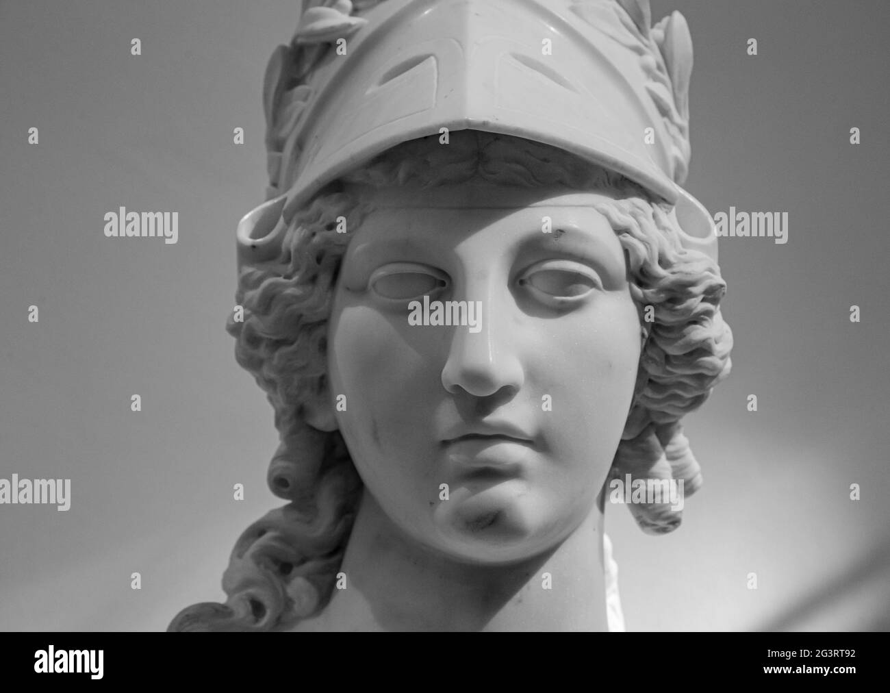Greek ancient statue of goddess Athena. Woman marble head in helmet sculpture Stock Photo