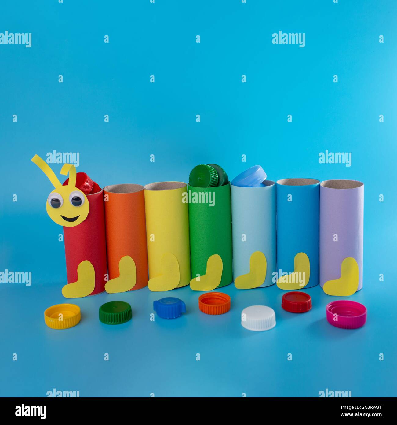 simple activity for kids, toilet paper roll craft, colorful tubes on blue background Stock Photo