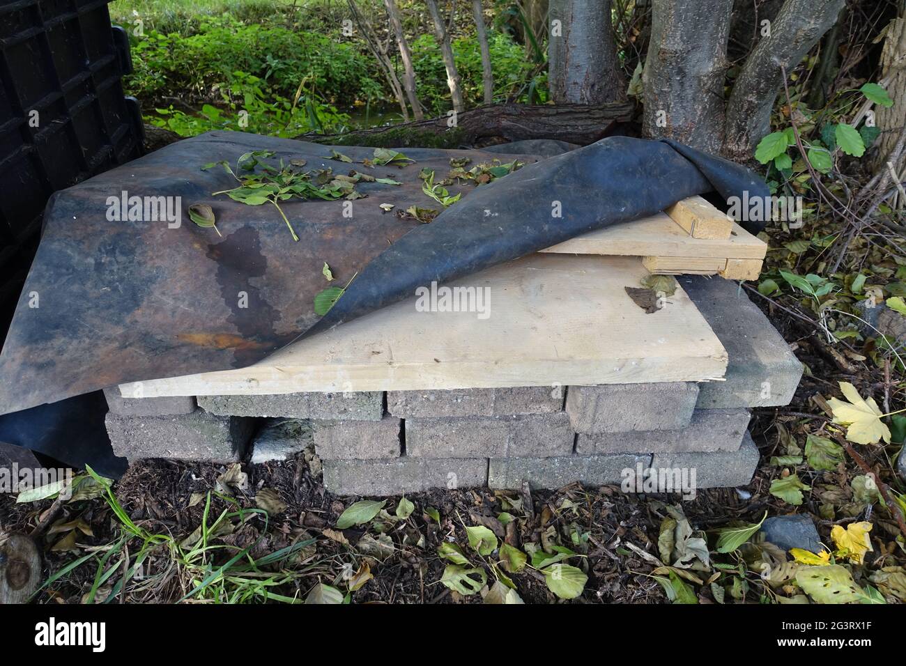 Hedgehog house for the winter with roof made of wooden boards and waterproof pond liner Stock Photo