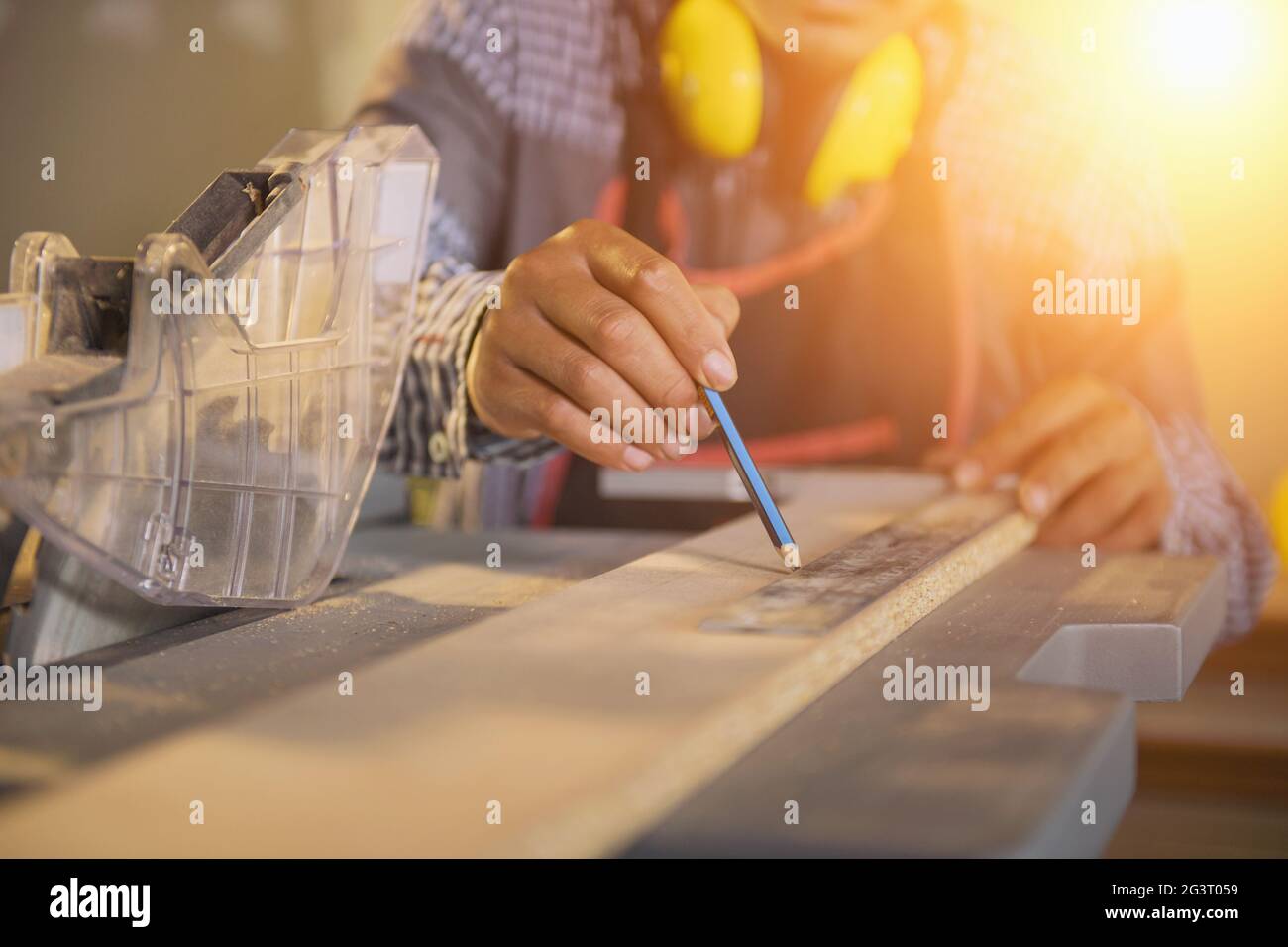 Carpenter working with equipment on wooden table in carpentry sh Stock Photo