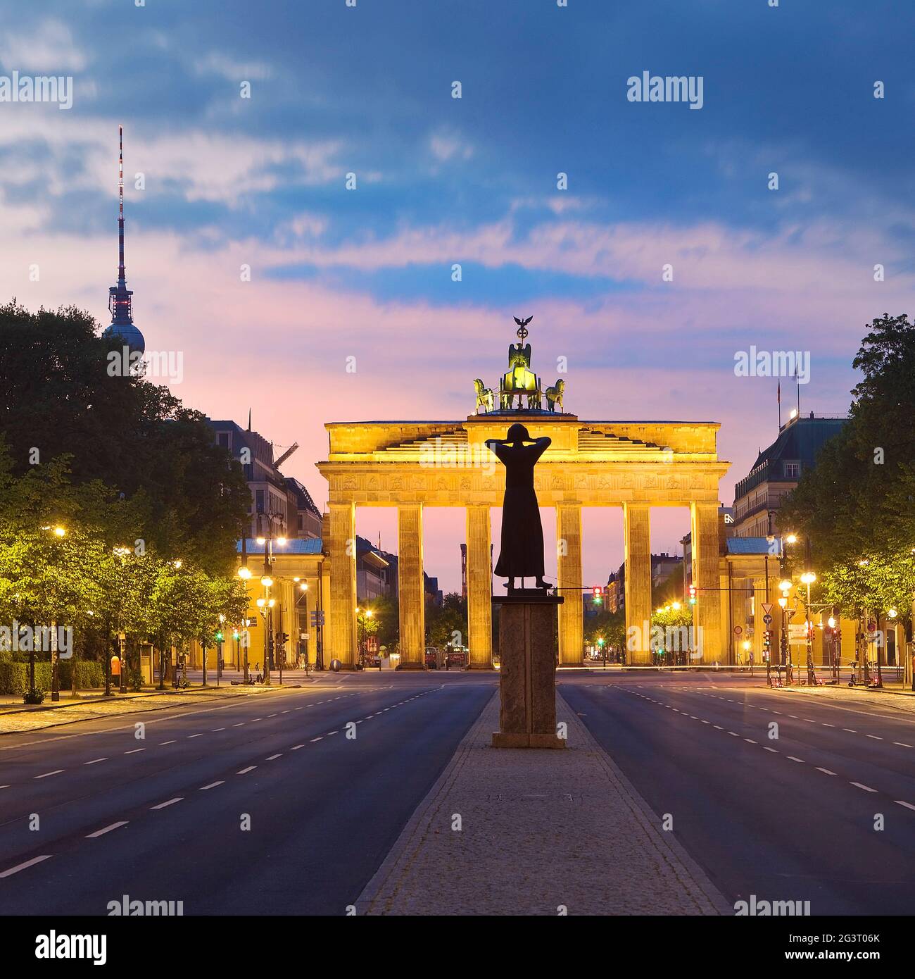 empty Strasse des 17. Juni in morning glow with Brandenburger Tor, sculpture , Germany, Berlin Stock Photo