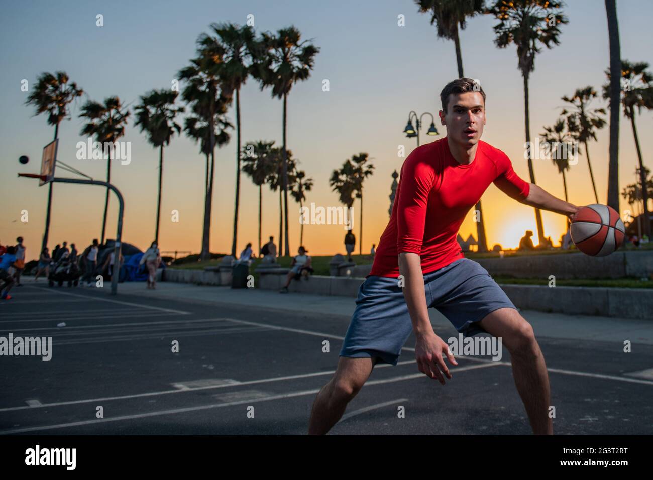 Basketball player dribbling the ball between his legs Stock Photo Alamy