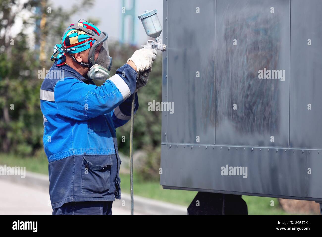Industrial Work Priming Of Metal Products From The Compressor Gun A Worker In Overalls And A Protective Mask Paints The Body O Stock Photo Alamy