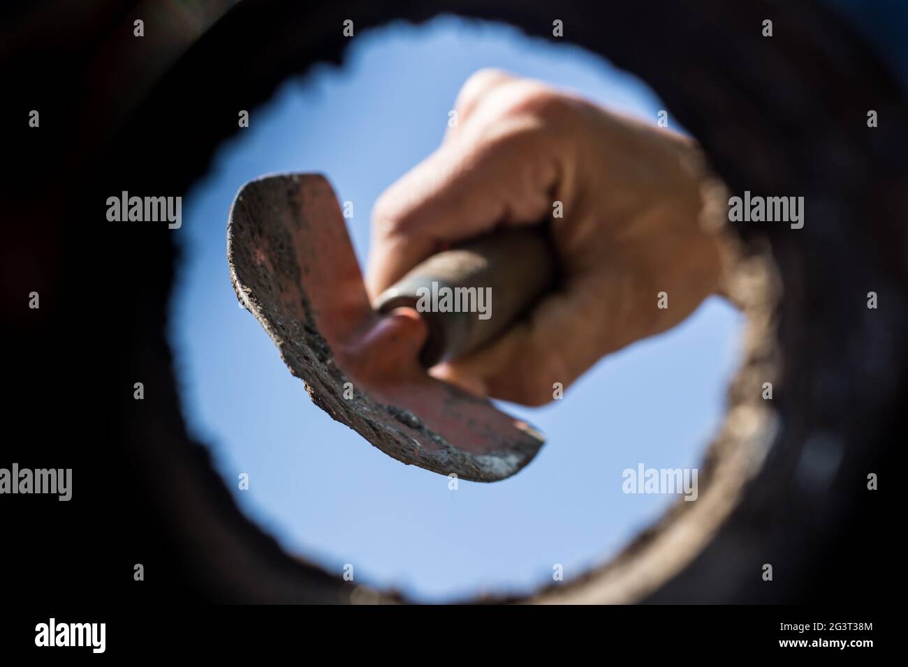 The hardworking hand that cultivates the garden seen from the inside of the earth Stock Photo