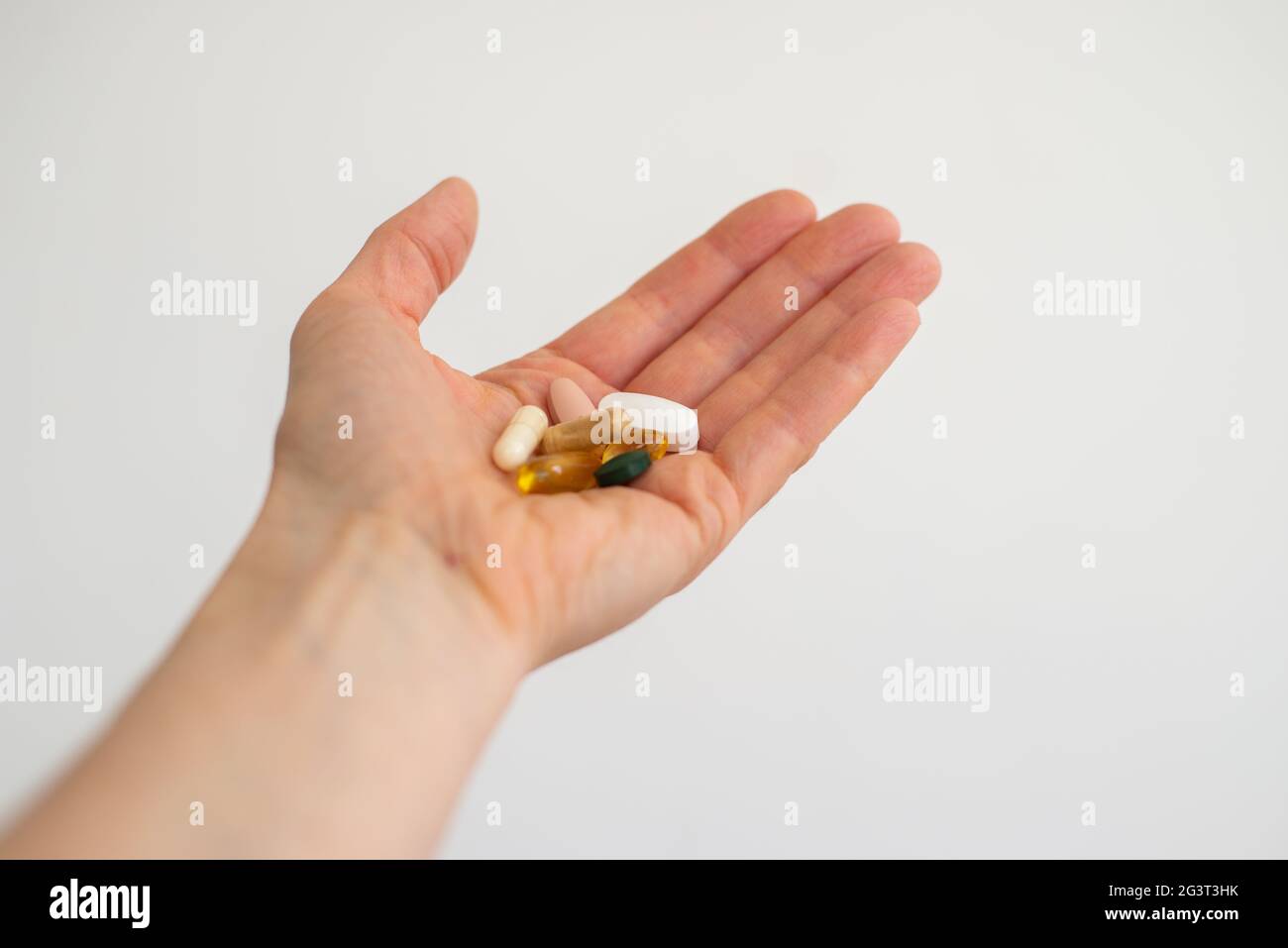 Multivitamin, Vitamin D, Ubiquinol Coq10, Spirulina, Royal Jelly, Vitamin E  supplements in open hand Stock Photo - Alamy