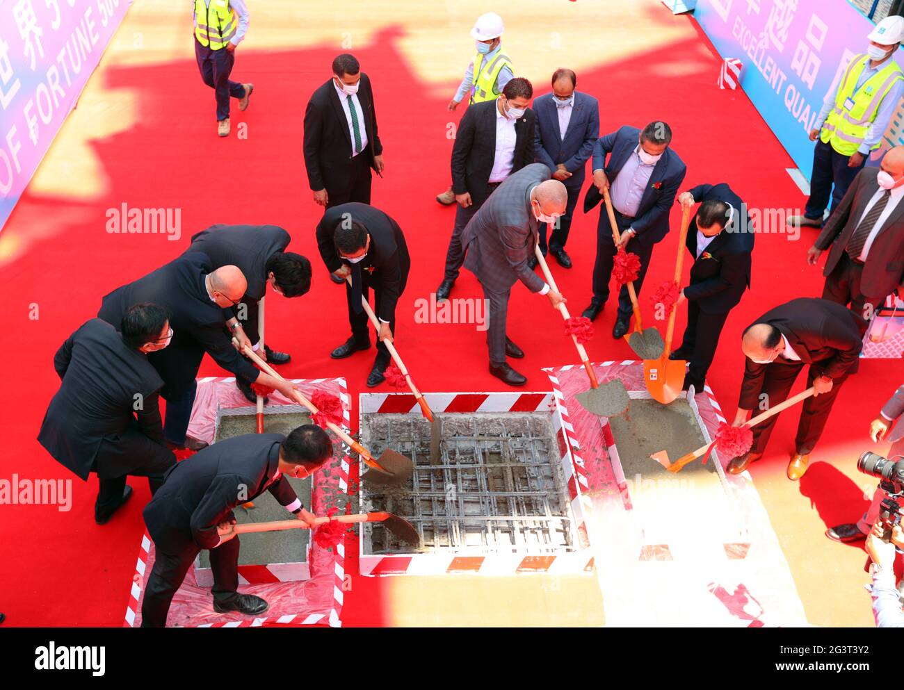 New Administrative Capital, Egypt. 17th June, 2021. Guests take part in a topping-out ceremony of the Iconic Tower at the construction site of the central business district (CBD) project in new administrative capital, Egypt, on June 17, 2021. With a commanding view of the modern buildings sprouting up in the central business district (CBD) of Egypt's new administrative capital, guests from China and Egypt on Thursday held a topping-out ceremony for the 385-meter-high Iconic Tower, which will be the tallest building in Africa upon completion. Credit: Sui Xiankai/Xinhua/Alamy Live News Stock Photo