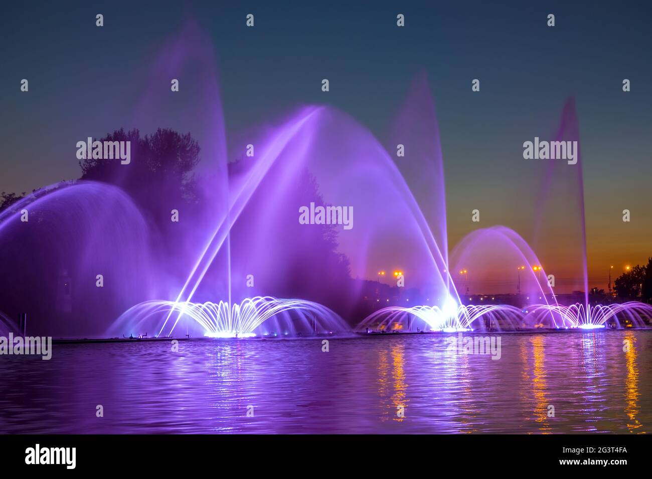 City Fountain with Evening Illumination Stock Photo - Alamy
