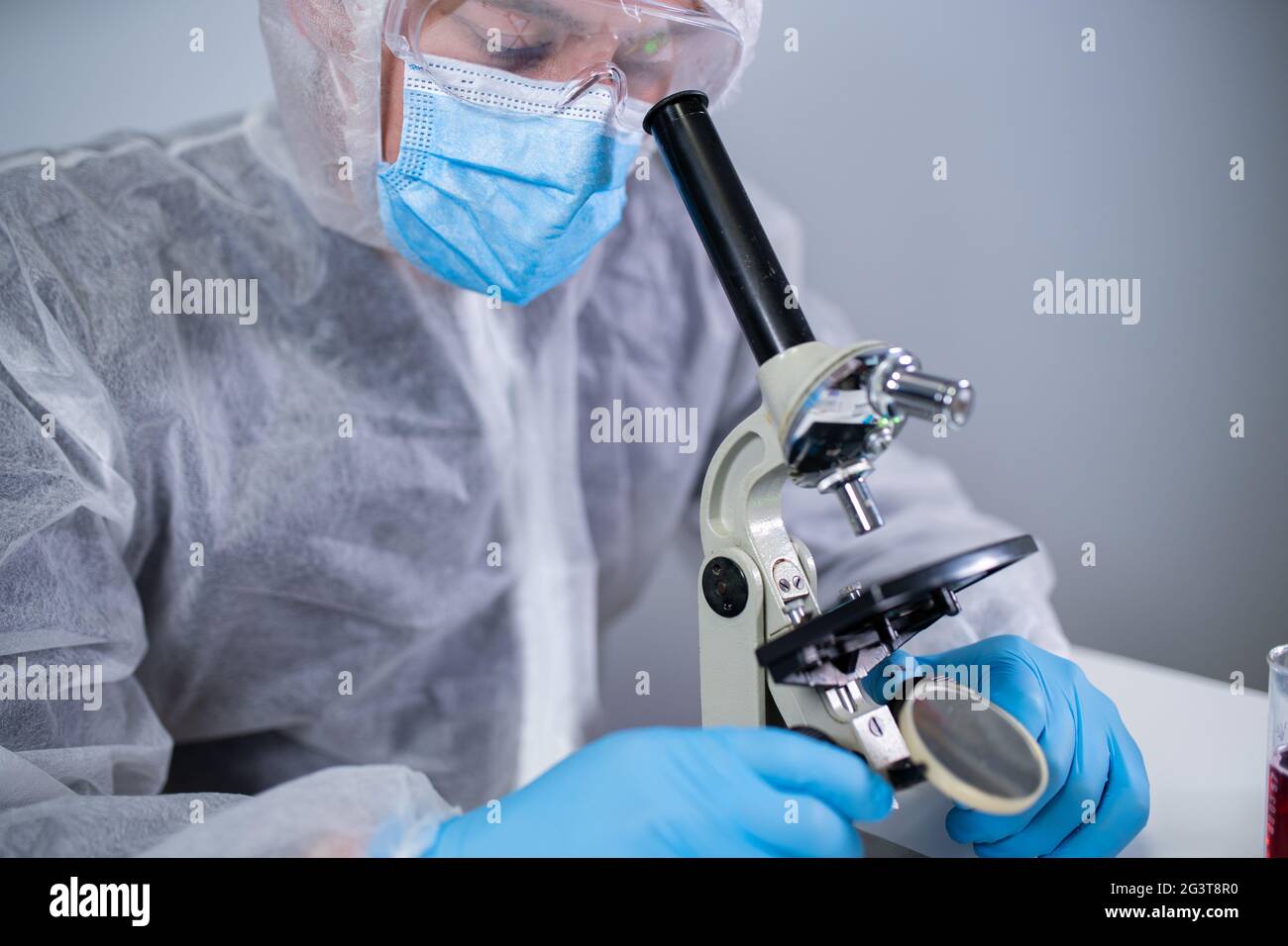 Pharmaceutical manufacturers developing viral medicines by inventing best ingredient. Scientist wearing personal protective equi Stock Photo