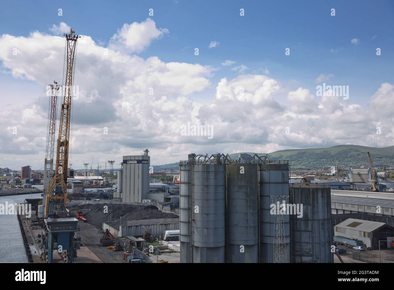 Belfast dockland and Larsen Company with Carrs glen and Napoleon's Nose in the background in Belfast, Ireland, UK. Stock Photo